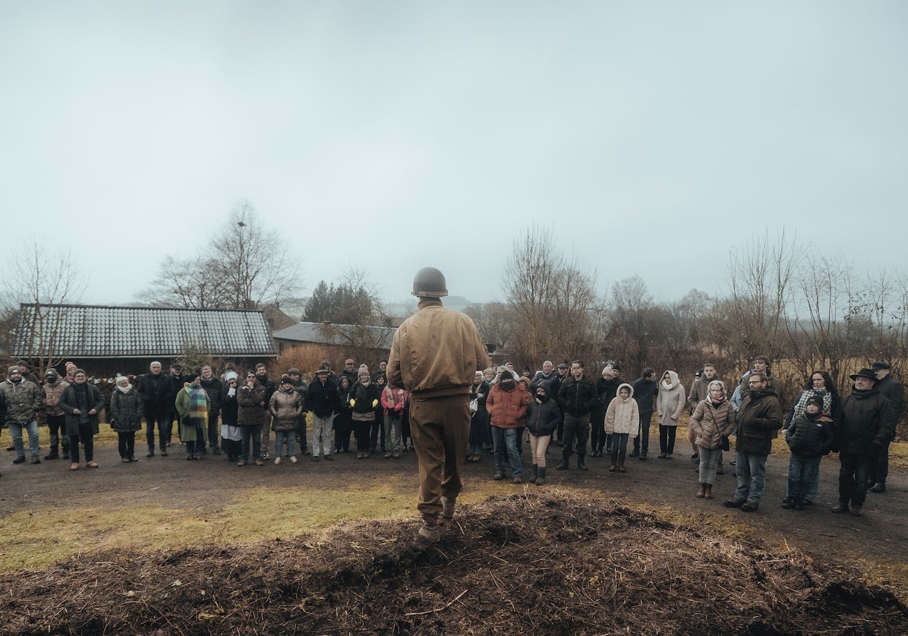 Battlefield Tour at Marcouray — reenacted soldier addressing participants in the winter mist of the Ardennes