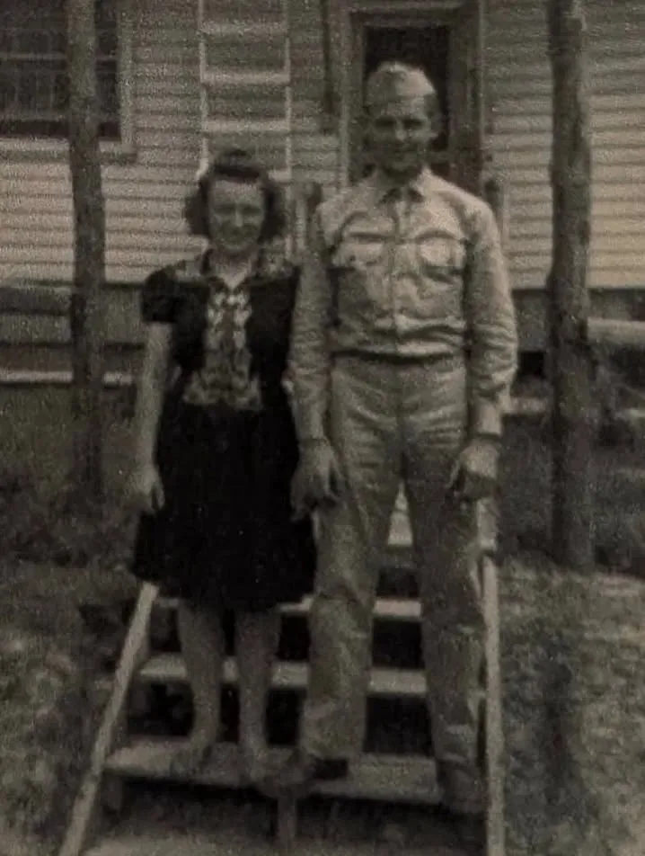 Elma Heitz and Everett Schafer in front of a Camp Forrest barracks, Tennessee